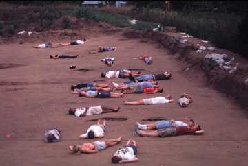 Field School Participants laying within the post molds