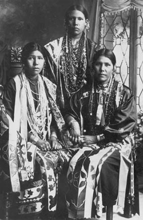 Edna, Nellie and Agnes Eagle dressed in beaded outfits with lavish jewelry and beading.