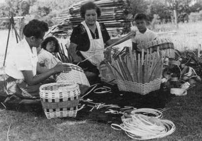 Angeline White Bear Thunder and Rosella Thunder Mallory making baskets, Joyce Mallory and Curtis Mallory watching.