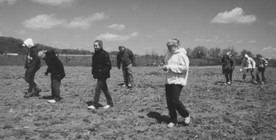 Students walking plowed fields 