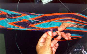 Close up of Linda finger weaving