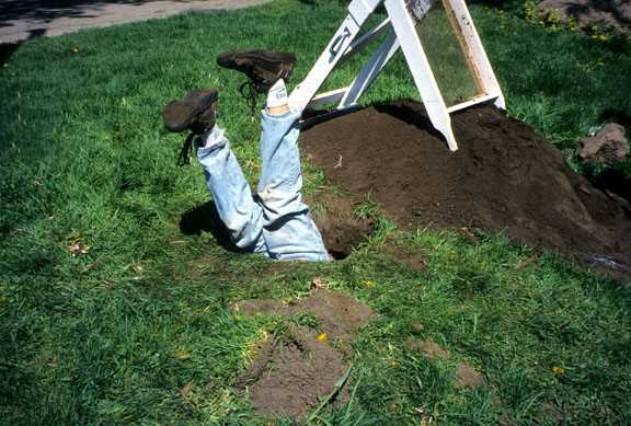Person in shovel test hole 