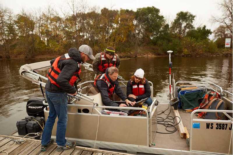 Dr. Colin Belby and students on pontoon boat