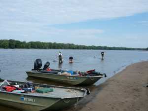 Two flat bottom boats on shore