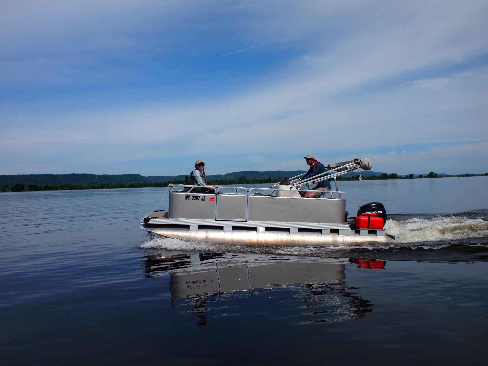 Graduate students on pontoon boat