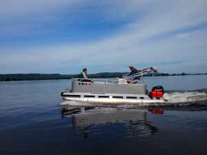 Graduate students on pontoon boat