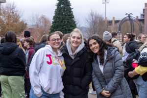 Three students at the 2025 UWL Campus Holiday Tree Lighting.
