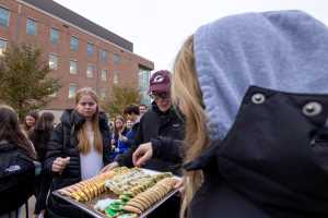 Chancellor James Beeby handing out cookies at the Campus Holiday Tree Lighting.