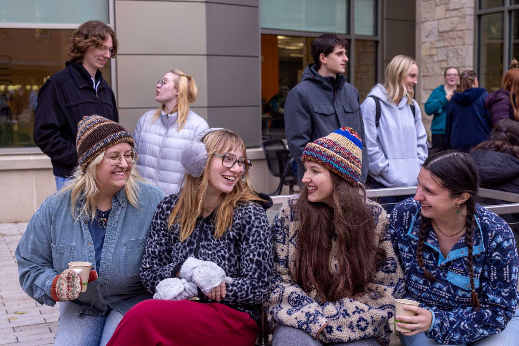 Four students laughing together at the Campus Holiday Tree Lighting.