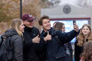 Two students take a picture with Chancellor James Beeby.