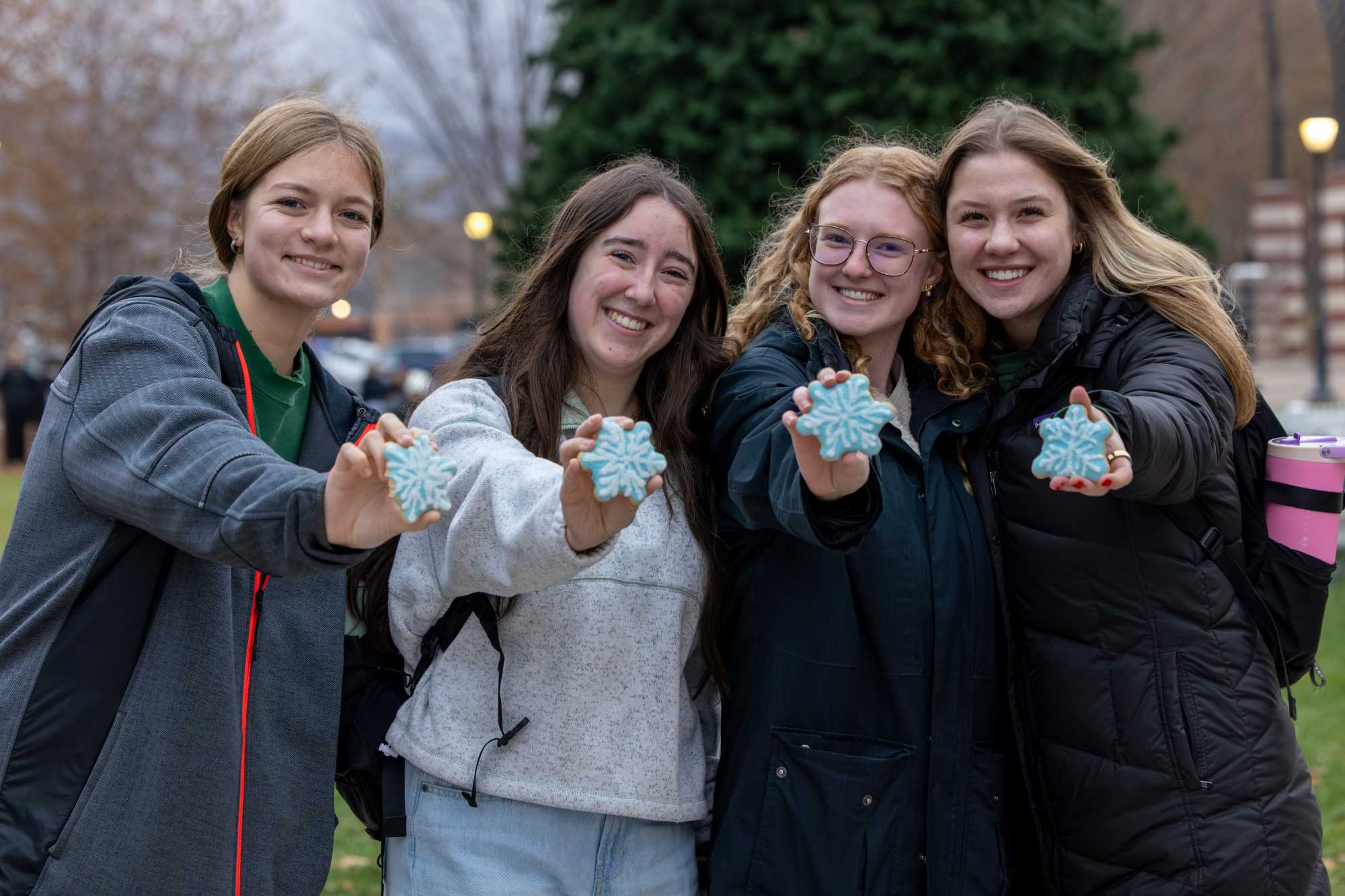 Four students at the 2025 UWL Campus Holiday Tree Lighting.