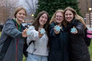 Four students at the 2025 UWL Campus Holiday Tree Lighting.
