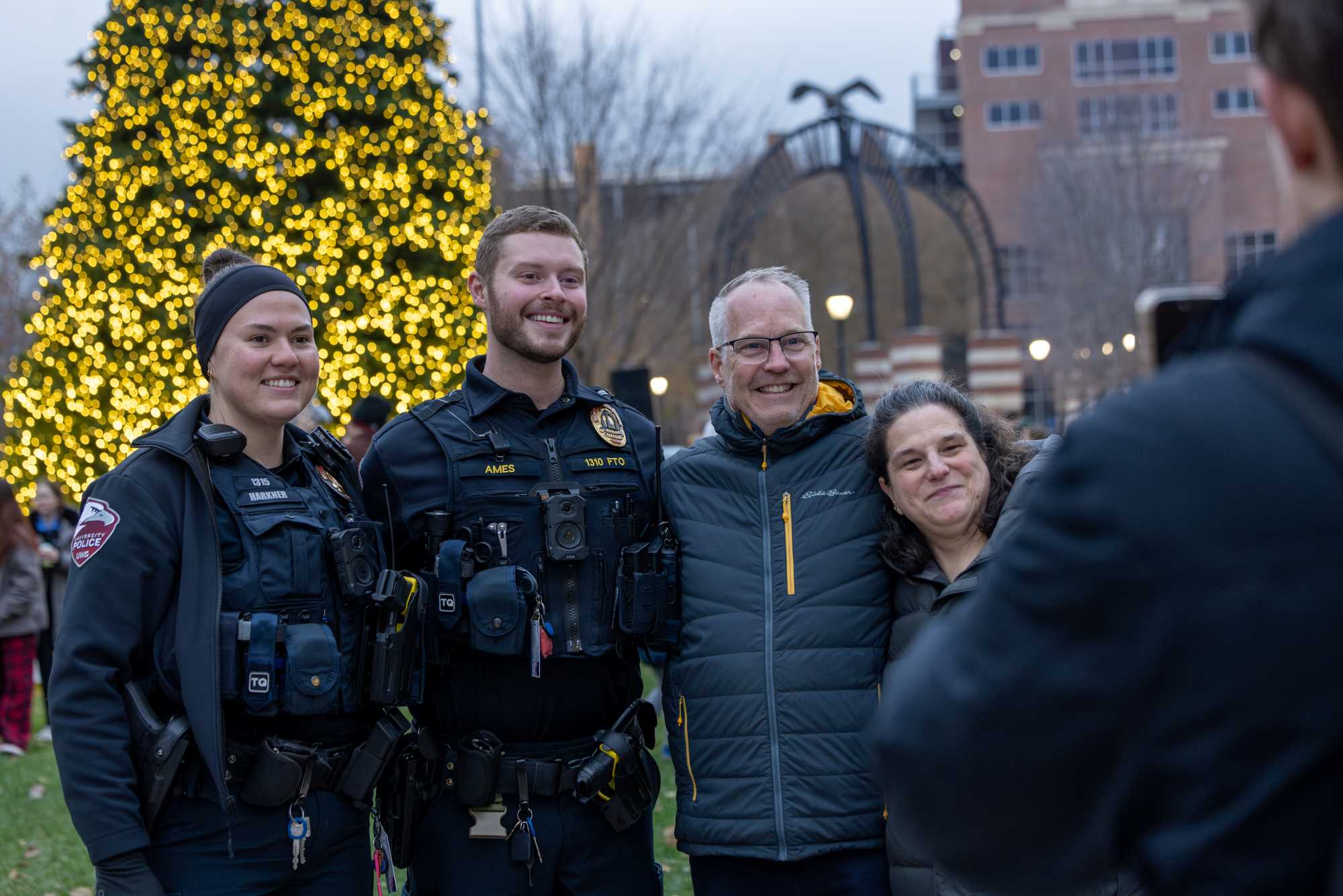 UWL employees in front of the Campus Holiday Tree.