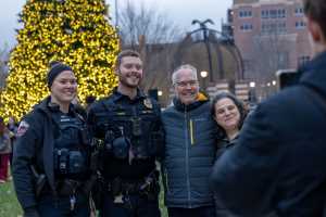 UWL employees in front of the Campus Holiday Tree.