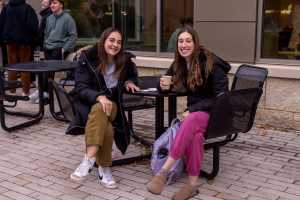 Two students waiting for the Campus Holiday Tree Lighting.