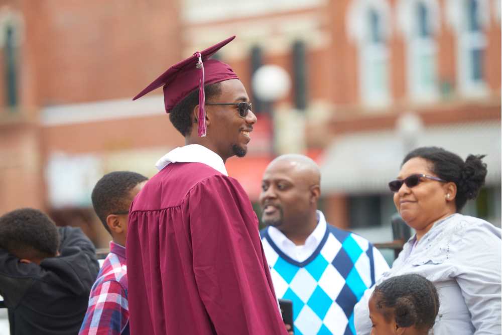 Graduating student outside with family