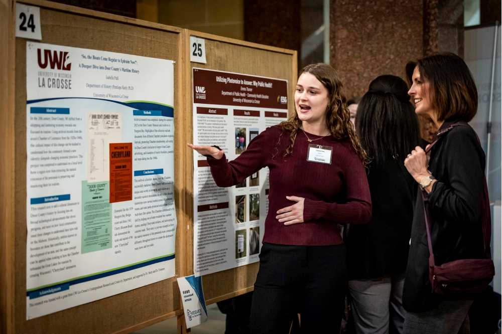 Student presenting a poster at Research in the Rotunda 2026