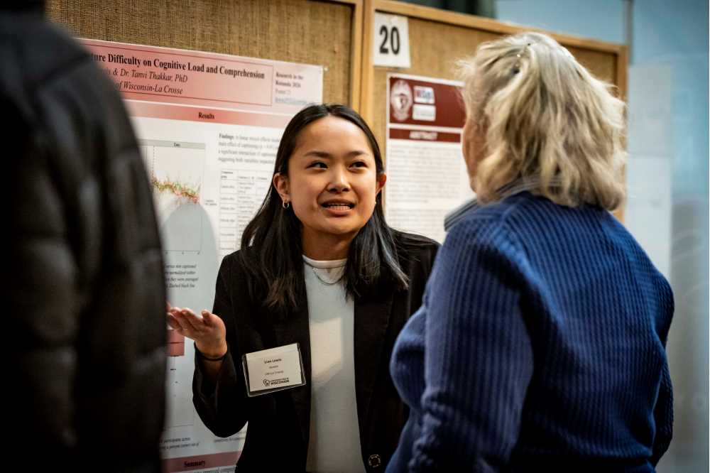 Student presenting a poster at Research in the Rotunda 2026