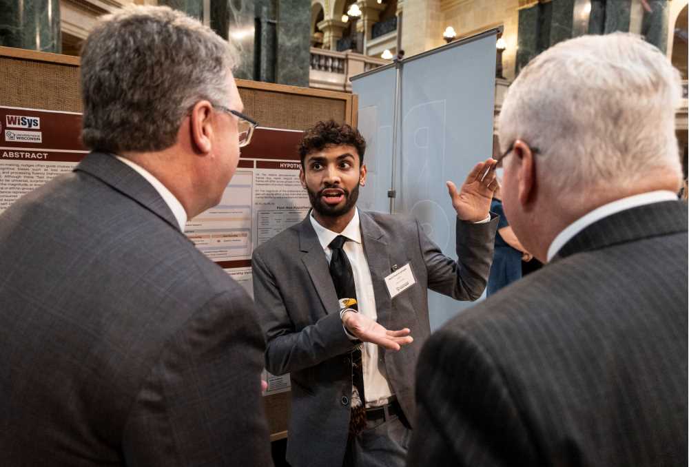 Student presenting a poster at Research in the Rotunda 2026