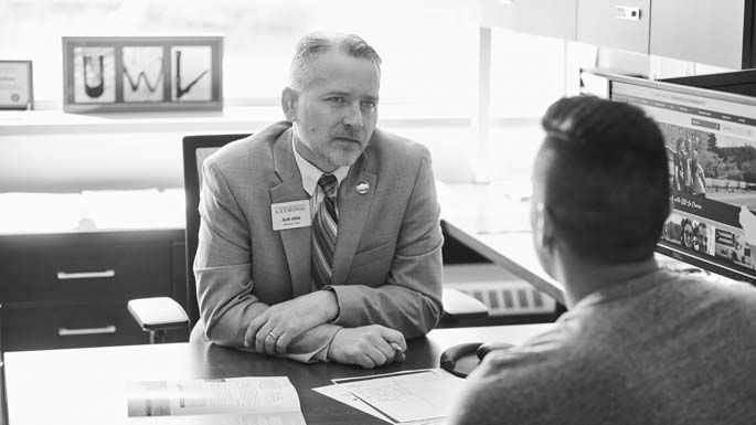 Scott Johns, UWL assistant director of admissions, meets with Ryan Crain. Although Ryan didn't meet the academic requirements for UWL, Johns noticed a certain energizing quality in him. He helped Ryan transfer to UWL.